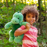 15" Cuddle Chunk Dinosaur - Green dinosaur in an outdoor scene with a child image number 1
