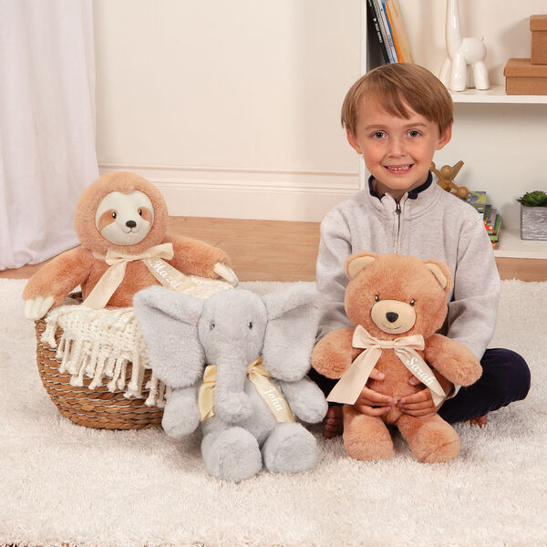 13" Cuddle Cub Elephant with Bow - Bear, Elephant and Sloth in a bedroom scene with a boy in pajamas image number 2