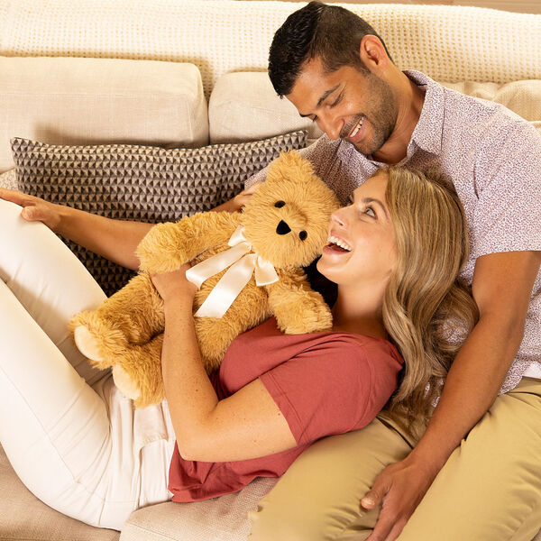20" World's Softest Bear - Front view of bear with models in a living room scene